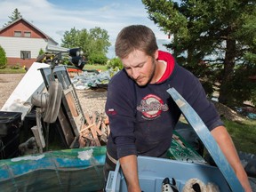 Steve Gray works to clean out his home in Arborfield on Wednesday, July 13, 2016, after five feet of flood waters destroyed everything in his basement.