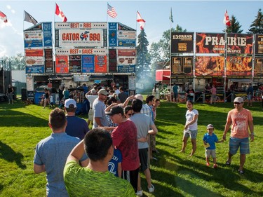 The lineup for meaty treats is a long one in front of the Gator BBQ booth during Saskatoon Ribfest at Diefenbaker Park in Saskatoon on July 29, 2016.