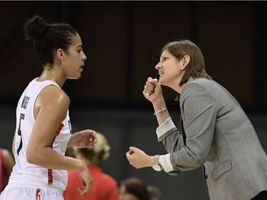 Canada's guard Kia Nurse (L) speaks with Canada's head coach Lisa Thomaidis during a Women's round Group B basketball match between Canada and Serbia at the Youth Arena in Rio de Janeiro on August 8, 2016 during the Rio 2016 Olympic Games. /