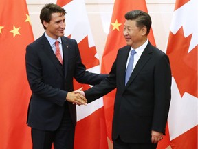 Chinese President Xi Jinping  greets Prime Minister Justin Trudeau ahead of their meeting in Beijing, on a visit to boost bilateral trade.