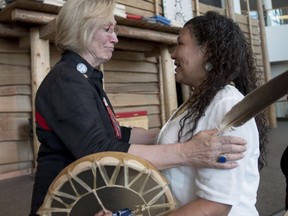 After the announcement of the terms for the inquiry, Indigenous Affairs Minister Carolyn Bennett embraces Ceejai Julian, who has lost two sisters.