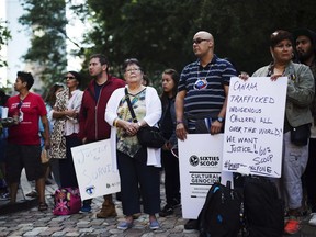 Dokis Thibault, centre, gathers with supporters for a demonstration at a Toronto courthouse on Tuesday, August 23, 2016. Scores of aboriginals from across Ontario rallied in Toronto today ahead of a landmark court hearing on the so-called '60s Scoop.