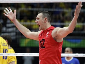 Canada's Gavin Schmitt celebrates during a men's preliminary volleyball match against Brazil at the 2016 Summer Olympics in Rio de Janeiro, Brazil, Tuesday, Aug. 9, 2016.