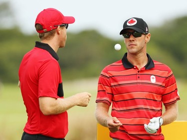 RIO DE JANEIRO, BRAZIL - AUGUST 08:  Graham Delaet (R) and David Hearn of Canada wait on a tee box during a practice round during Day 3 of the Rio 2016 Olympic Games at Olympic Golf Course on August 8, 2016 in Rio de Janeiro, Brazil.