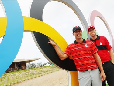 RIO DE JANEIRO, BRAZIL - AUGUST 08:  Graham Delaet (L) and David Hearn of Canada pose near the clubhouse during a practice round during Day 3 of the Rio 2016 Olympic Games at Olympic Golf Course on August 8, 2016 in Rio de Janeiro, Brazil.