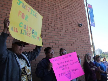 Jonathan Cardinal, a participant at a Justice for Colten Boushie rally, holds up a sign outside of the Saskatoon Provincial Courthouse on Thursday morning, August 18, 2016. Approximately 50 people attended the rally, which was one of several taking place across Saskatchewan.