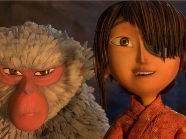 L-R: Monkey (voiced by Charlize Theron) situates herself protectively alongside Kubo (voiced by Art Parkinson) in "Kubo and the Two Strings."