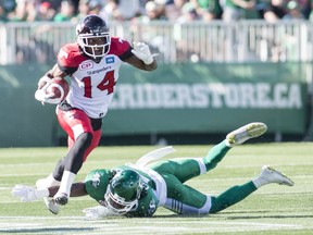 The Calgary Stampeders' Roy Finch, 14, avoids a tackle from the Saskatchewan Roughriders' Major Culbert during Saturday's CFL game at Mosaic Stadium.