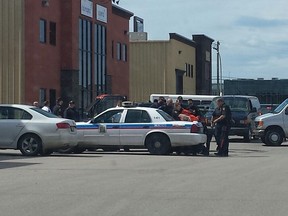Members of the Saskatoon Police Service make an arrest following the escape of an inmate from the Saskatoon Correctional Centre on Wednesday afternoon. Two men attempted to escape the facility, but one was apprehended before successfully escaping. The second man, who police say is 24-years-old, was arrested in the 3500 block of Miller Avenue where he was found hiding in a garbage bin.