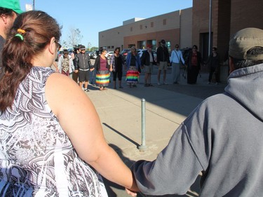 Participants at a Justice for Colten Boushie rally in Saskatoon join hands outside of Saskatoon's provincial courthouse on Thursday morning, August 18, 2016. Roughly 50 people attended the rally, which was one of several taking place across Saskatchewan as the man accused of second-degree murder in Boushie's death, Gerald Stanley, appeared in court in North Battleford.