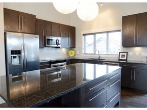 Pawluk Homes has created a beautiful family-friendly home, featuring stainless steel appliances, granite countertops, an oversized island and a contemporary lighting package.