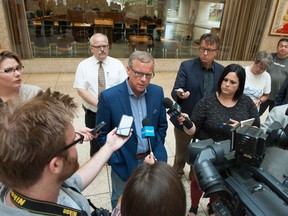 Premier Brad Wall stands in front of Prince Albert mayor Greg Dionne during a press conference at Prince Albert City Hall regarding the effects of the oil spill from a Husky Energy pipeline into the North Saskatchewan River. August 3, 2016.