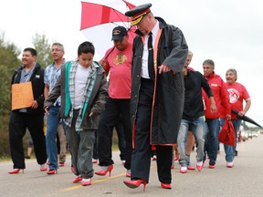 Prince Albert police Chief Troy Cooper walked in red high heels with Mason Isbister (center) and others during the annual Walk for Missing and Murdered Indigenous women at Ahtahkakoop First Nation on Aug. 23, 2016.