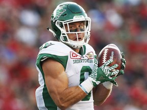 Saskatchewan Roughriders' Rob Bagg catches a touchdown pass in first-half CFL action against the Calgary Stampeders on Thursday.