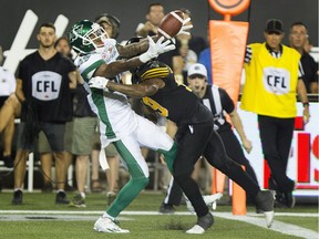 Saskatchewan Roughriders wide receiver Caleb Holley, left, made his CFL debut on Saturday against the host Hamilton Tiger-Cats.