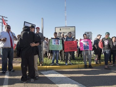 Family, friends and supporters hold signs during a rally for Colten Boushie outside of the Saskatchewan Provincial Court in North Battleford, August 18, 2016. People rally outside a Saskatchewan courthouse Thursday where a farmer accused of fatally shooting a First Nations man is to make an appearance.