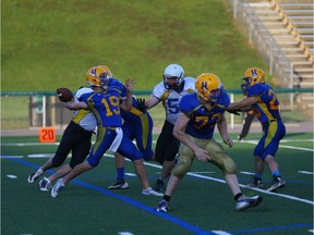 Saskatoon Hilltops quarter back Jordan Walls, gets ready to attempt a pass during the Hilltops Alumni Game on Thursday night. The event took place at Saskatoon Minor Football field and saw current hilltops take to the gridiron against former players from the team.