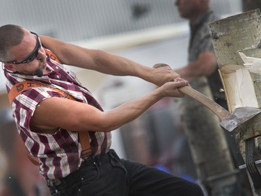 Darren Dean of the West Coast Amusement Lumberjack Show swings a mighty axe at the Saskatoon Ex, August 10, 2016.