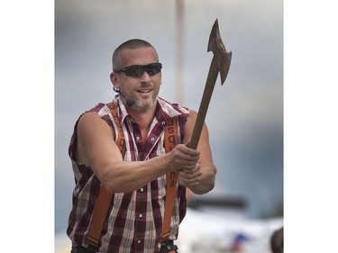 Darren Dean of the West Coast Amusement Lumberjack Show swings a mighty axe during the axe target throwing part of the show at the Saskatoon Ex, August 10, 2016.
