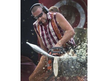 Darren Dean of the West Coast Amusement Lumberjack Show runs his high powered chainsaw up and down through a log in seconds, part of the show at the Saskatoon Ex, August 10, 2016.