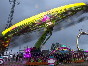 West Coast Amusements lights up the midway at the Saskatoon Ex on a dark cloudy evening, August 10, 2016.