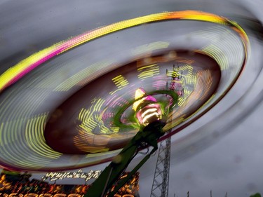 West Coast Amusements lights up the midway at the Saskatoon Ex on a dark cloudy evening, August 10, 2016.