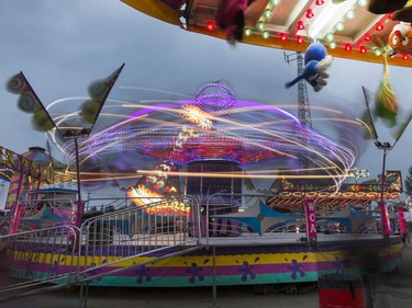 West Coast Amusements lights up the midway at the Saskatoon Ex on a dark cloudy evening, August 10, 2016.