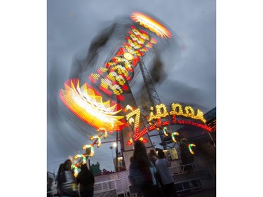 West Coast Amusements lights up the midway at the Saskatoon Ex on a dark cloudy evening, August 10, 2016.