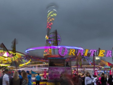 West Coast Amusements lights up the midway at the Saskatoon Ex on a dark cloudy evening, August 10, 2016.