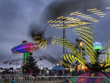 West Coast Amusements lights up the midway at the Saskatoon Ex on a dark cloudy evening, August 10, 2016.