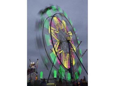 West Coast Amusements lights up the midway at the Saskatoon Ex on a dark cloudy evening, August 10, 2016.