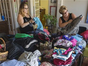 Sue Delanoy and helpers fold clothing collected for inmates of the Pine Grove women's jail, August 16, 2016 (GORD WALDNER/Saskatoon StarPhoenix)