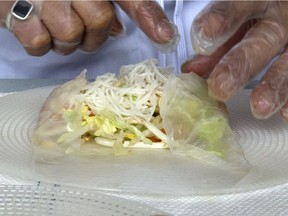 A Saigon Roll chef demonstrates the preparation of a spring roll - one of the featured items on the menu at the Vietnamese pavilion for this year's Folkfest.