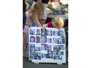 The sights and sounds of the Saskatoon Fringe Festival included two little girls picking out the tattoos they wanted, August 2, 2016.