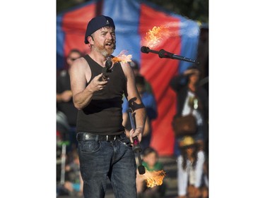 Street performer Russ came all the way from Australia to juggle up some fire sticks for a large crowd at the at the Fringe Festival, August 2, 2016.