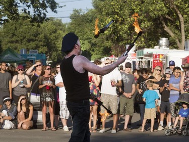 Street performer Russ came all the way from Australia to juggle up some fire sticks for a large crowd at the at the Fringe Festival, August 2, 2016.