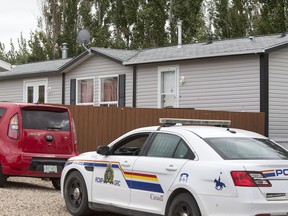 RCMP on the scene in Delisle Sask. where two people in their late 20's were found dead in this home at 311 4th St. W.