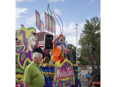The annual Mardi Gras Parade with Noodles the Clown makes its way through the exhibition food stand road before circling through the midway at the Saskatoon Ex at Prairieland Park, August 9, 2016.