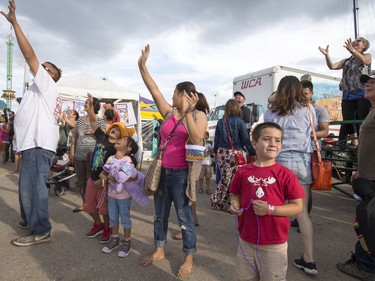 The annual Mardi Gras Parade with Noodles the Clown makes its way through the exhibition food stand road before circling through the midway at the Saskatoon Ex at Prairieland Park, August 9, 2016.