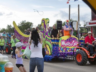 The annual Mardi Gras Parade with Noodles the Clown makes its way through the exhibition food stand road before circling through the midway at the Saskatoon Ex at Prairieland Park, August 9, 2016.