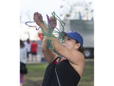 The annual Mardi Gras Parade with Noodles the Clown makes its way through the exhibition food stand road before circling through the midway at the Saskatoon Ex at Prairieland Park, August 9, 2016.