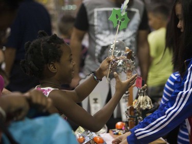 Ela Udemgba plays with a toy bubble at the Philippines Pavilion at Prairieland Park in Saskatoon, August 20, 2016.