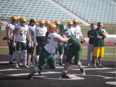 A player from Alberta's Golden Bears runs a drill against #62 Nicholas Summach at Griffiths Stadium during an exhibition game against the U of S Huskies in Saskatoon, August 20, 2016.