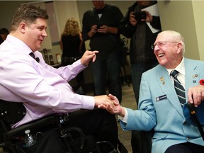 Minister of Veterans Affairs and Associate Minister of National Defence Kent Hehr speaks with veteran David W. Robinson after announcing the plan to re-open the Veteran Affairs office by November 2016 in Saskatoon on August 10, 2016