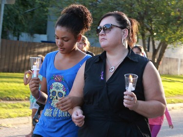 People gather to remember victims of the sex trade during the 16th Annual Day or Mourning Event at Pleasant Hill Park on August 14, 2016.