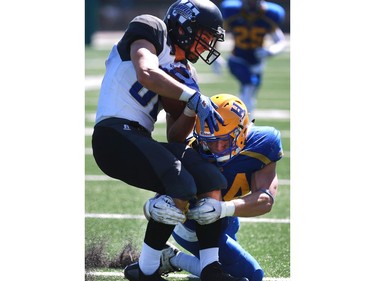 Saskatoon Hilltops' Cody Peters takes down Winnipeg Rifles' Xander Tachinski in their 2016 Prairie Football Conference season-opener at SMF Field on August 14, 2016.