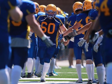 Saskatoon Hilltops' Drayke Unger takes on the Winnipeg Rifles in their 2016 Prairie Football Conference season-opener at SMF Field on August 14, 2016.