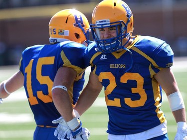 Saskatoon Hilltops' Ryan Turple and Tyler Sieffert celebrate a touchdown during the first half of their 2016 Prairie Football Conference season-opener against the Winnipeg Rifles at SMF Field on August 14, 2016.