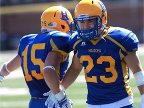 Saskatoon Hilltops' Ryan Turple and Tyler Sieffert celebrate a touchdown during the first half of their 2016 Prairie Football Conference season-opener against the Winnipeg Rifles at SMF Field on August 14, 2016.