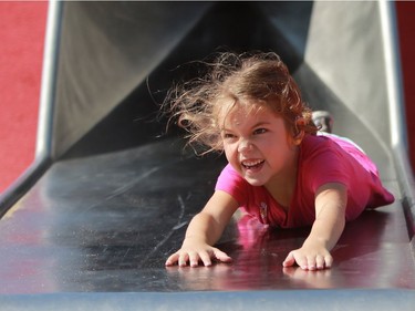 Seven-year-old Sarah Hinman goes head first down the Kinsmen Park slide in Saskatoon on Aug. 2, 2016.